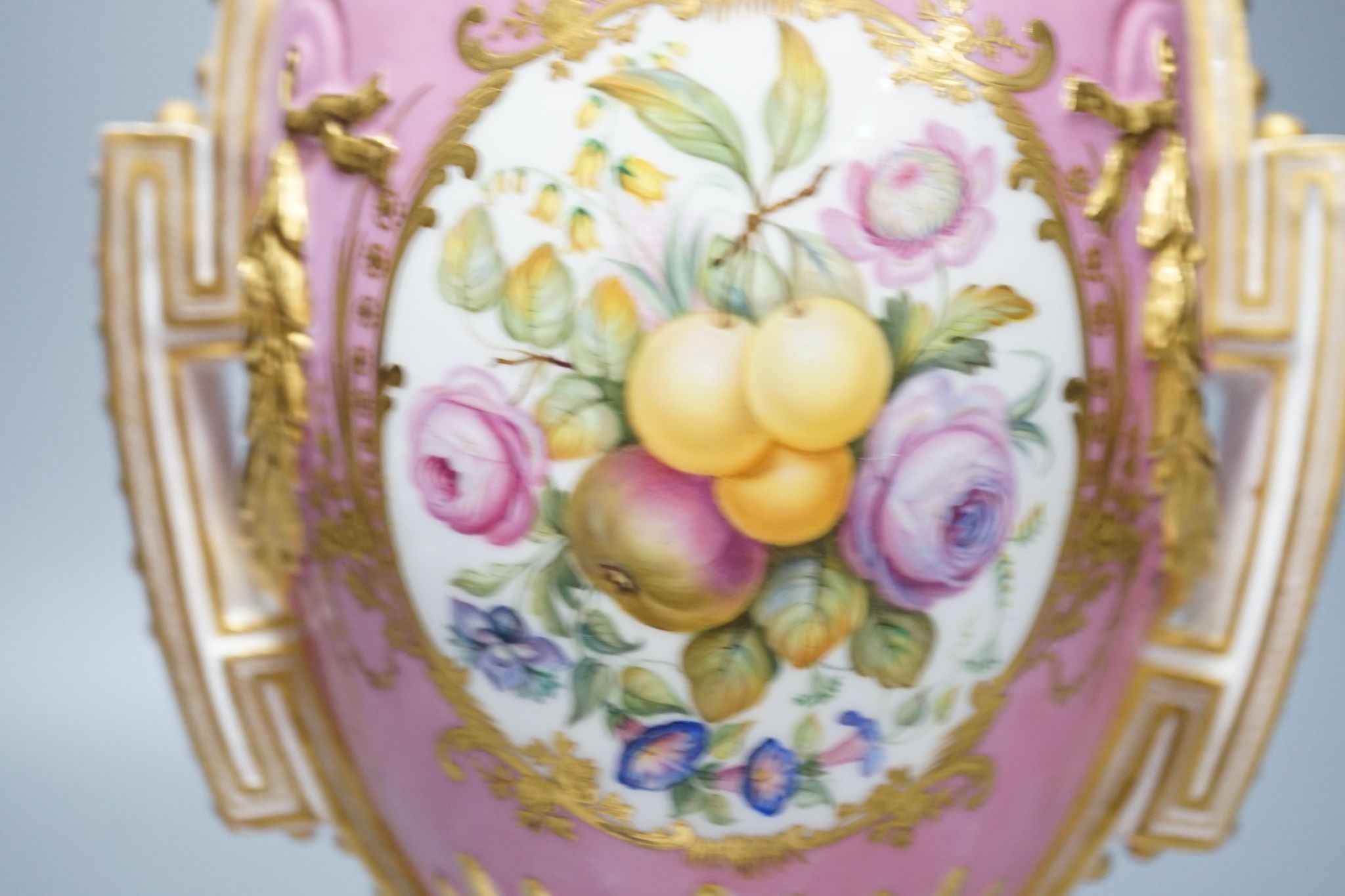 A Coalport two handled vase and cover painted with a Watteauesque scene to one side and a panel of fruit and flowers by William Cook 31cm